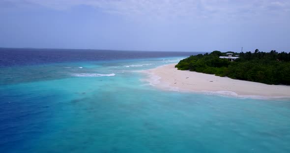 Beautiful flying copy space shot of a white sand paradise beach and aqua blue ocean background in hi