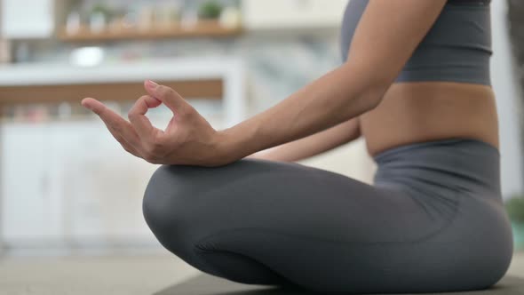 Portrait of Young African Woman Meditating on Yoga Mat at Home