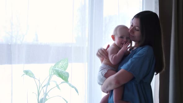 Beautiful Woman Holds a Newborn Baby