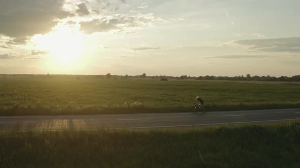 A Cyclist is Riding Fast on the Highway