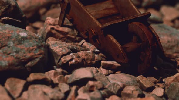 Abandoned Wooden Mine Wheelbarrow on Rocks