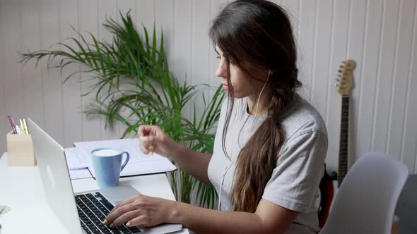 Female student using laptop at home