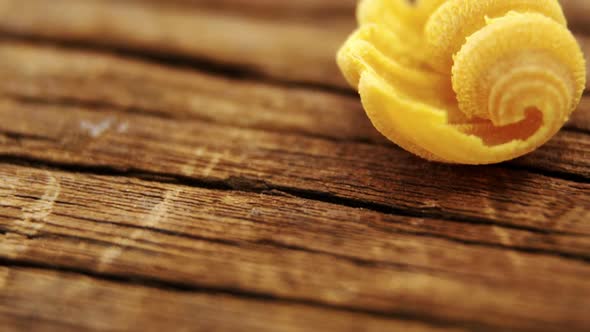 Yellow conchiglie pasta on wooden table