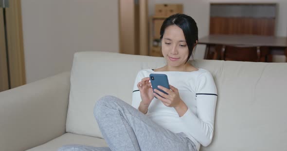 Woman use of smart phone at home