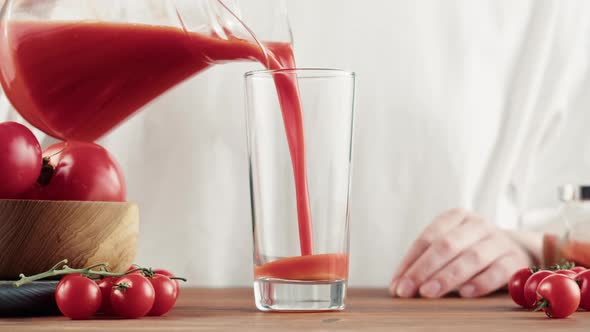 Woman Pouring Tomato Juice Fresh Red Vegetable Juice on Kitchen Table Vitamin c Italian and Spanish