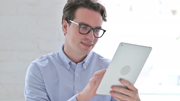 Portrait of Cheerful Young Man Using Tablet