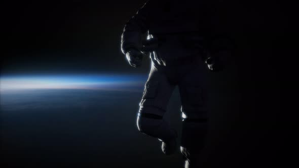 Astronaut in Outer Space Against the Backdrop of the Planet Earth