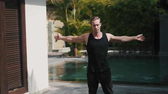 Fitness Sporty Caucasian Man Warmups in Nature in Front of Pool