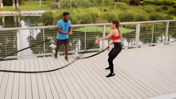 Aerial shot of a woman working out with a trainer in the park