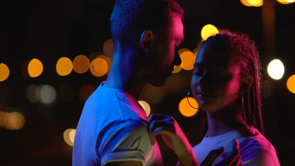 Loving Teenage Couple Embracing in Night Lights, Enjoying Romantic Atmosphere