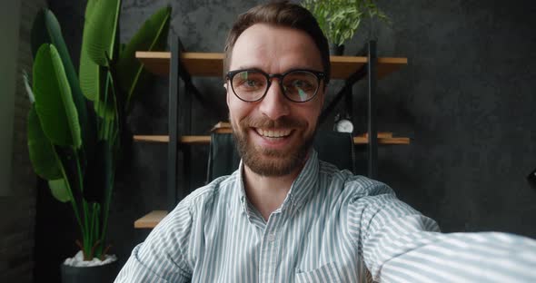 POV of Handsome Business Man Making Selfie Video Call While Sitting at Modern Office