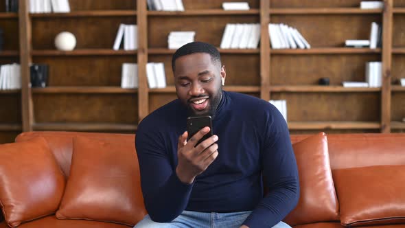 African Guy Using Smartphone for Video Call