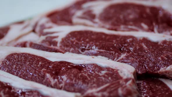 raw beef before grilling rosemary and garlic