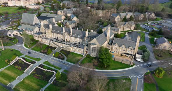 Huge retirement home community in United States. Gothic stone architecture. Aerial view during sprin