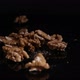 a hand puts walnuts on a mirror table - VideoHive Item for Sale