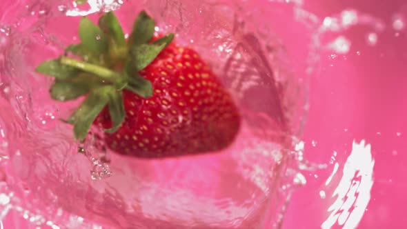 Super Slow Motion of Falling Strawberry Into Splashing Water