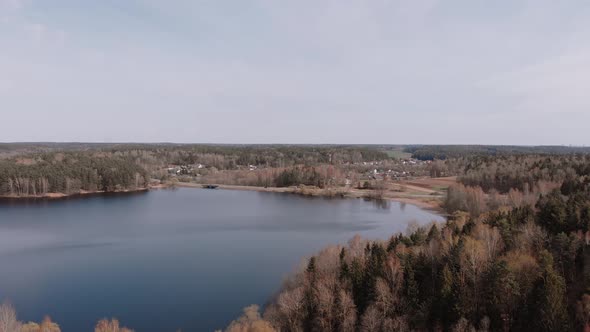 Aerial View of Flat Landscape with Lake Road and a Village