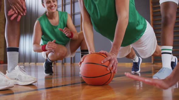 Diverse female basketball team wearing sportswear and doing push ups