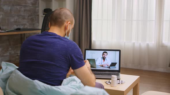 Man During Coronavirus Quarantine on a Video Call with Doctor