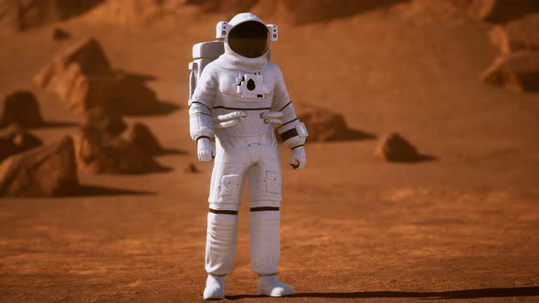 Astronaut on Mars Surface. Red Planet Covered in Gas and Rock alt