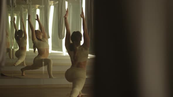 Slow Motion Young Woman is Doing Yoga in a Room with Mirrors Female Performs a Stretching with Yoga