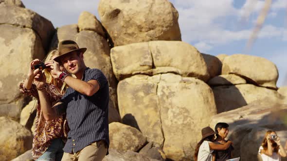 Young people on road trip look through binoculars