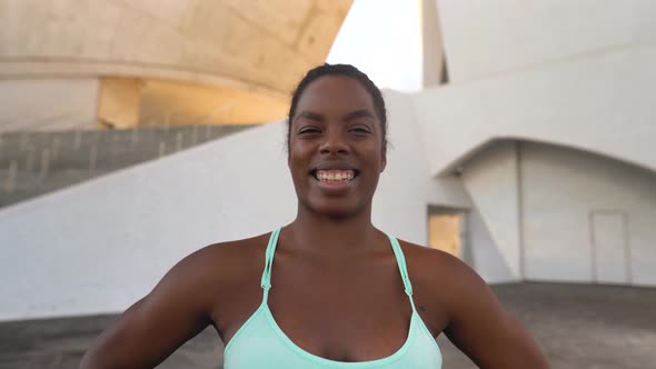 Young African fit woman smiling during workout session outdoor - Sport people lifestyle concept