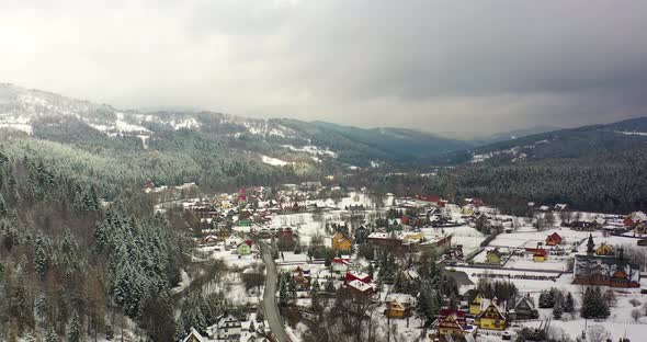 Forest Covered with Snow Aerial View. Aerial View of Village in Mountains