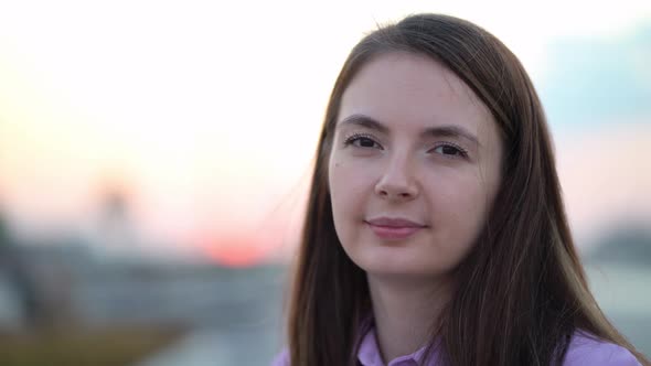 Close Up Portrait of Young Woman Smiling Looking at Camera at Sunset