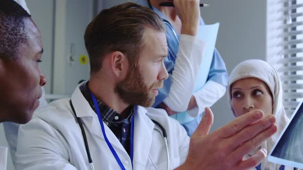 Close-up of Multi-Ethnic doctors discussing over x-ray report in hospital