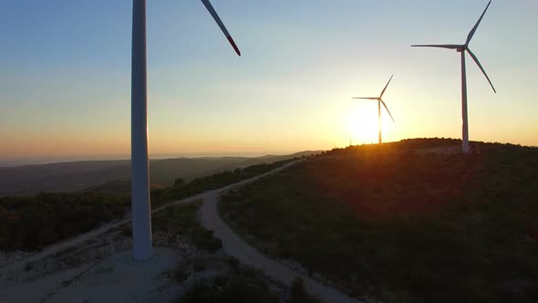 Aerial view from bottom to top of white wind turbines