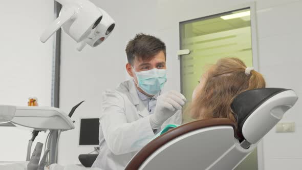 Young Girl Smiling To the Camera After Dental Examination at the Clinic