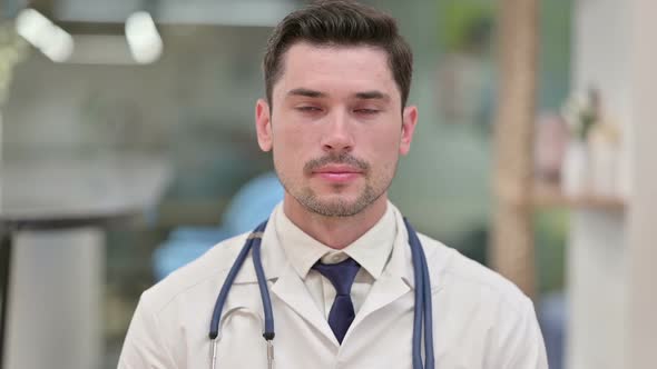 Serious Young Male Doctor Looking at the Camera