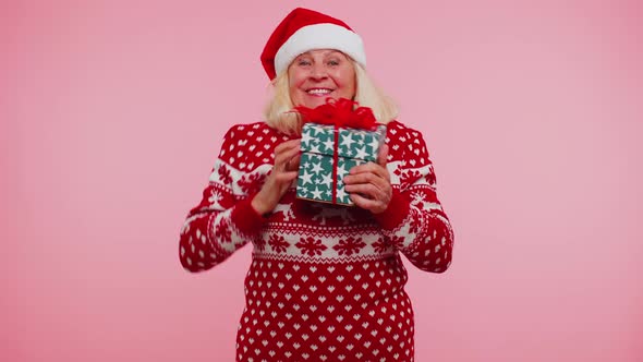 Grandmother Woman in Sweater Santa Christmas Getting Present Gift Box Expressing Amazement Happiness