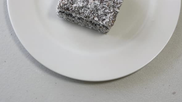 Lamington Cake On A White Plate DIRECTLY ABOVE