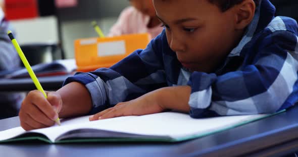 Attentive schoolkids doing their homework in classroom