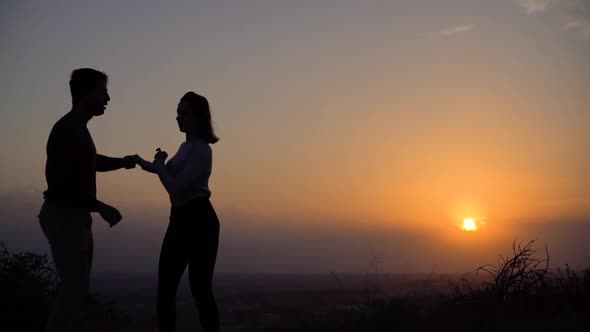 Young Passionate Couple of Professional Dancers Dancing at Sunset