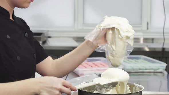 Cropped Shot of a Confectioner Putting Sour Cream into Pastry Bag