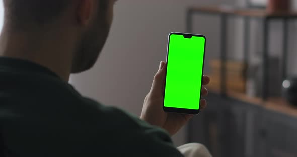 Online Chatting By Modern Social Nets Man Is Holding Smartphone with Green Screen and Talking with