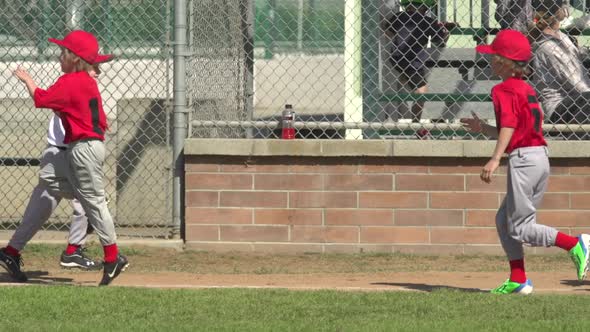 Kids playing little league baseball.