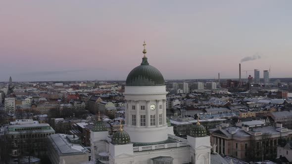 Aerial view drone flying close to the dome of Helsinki Cathedral and city in background.