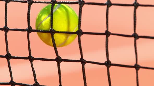 Super Slow Motion Shot of Tennis Ball Hitting the Net on Court at 1000Fps