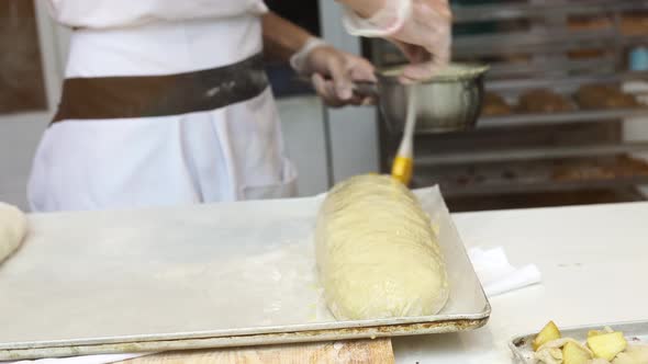 A Man Prepares an Apple Strudel for Sale