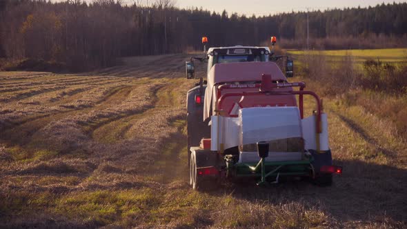 Harvester machines, harvesting on a wheat field, on the countryside, on a sunny day, in Soderhamn, S