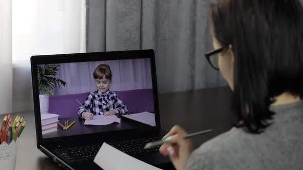 Woman Teacher Makes Video Call on Laptop with Children Pupil. Distance Education