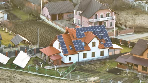 Residential House with Rooftop Covered with Solar Photovoltaic Panels for Producing of Clean