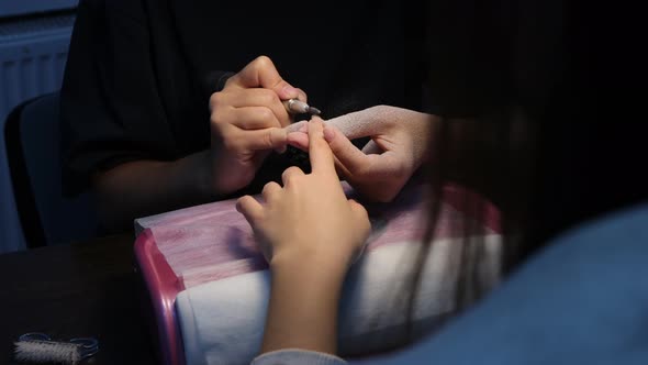 Anonymous Beautician Doing Manicure to Female Client