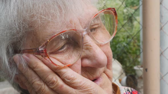 Portrait of Grandmother with Emotions and Feelings. Old Woman Looking with Sad Expression Outdoor