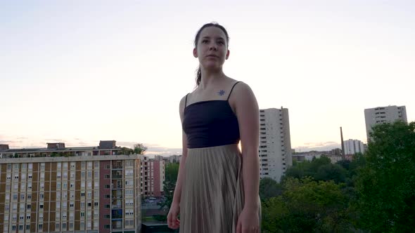 Portait of young woman at viewpoint during sunset