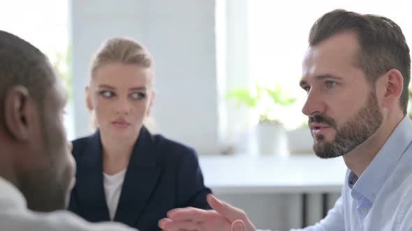 Close Up of Serious Male and Female Business People Talking